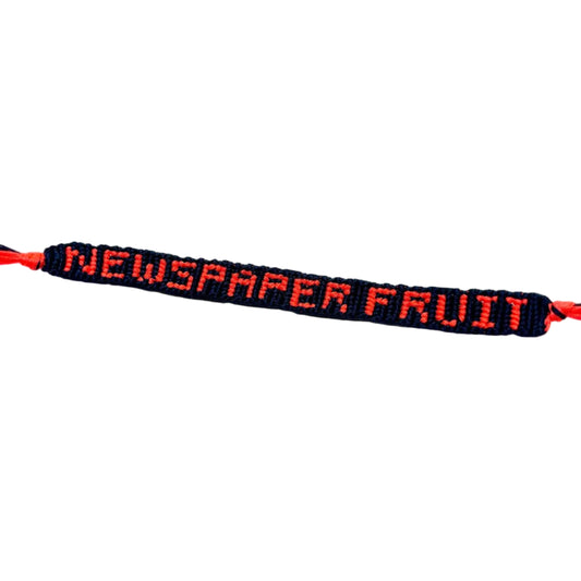 Bracelet with 'NEWSPAPER FRUIT' text on a white background